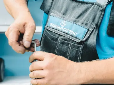 Plumber tightening a pipe fitting with a wrench